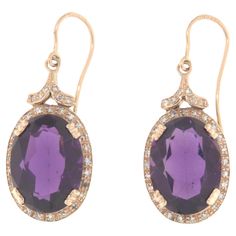 These elegant 14-karat yellow gold earrings are a perfect combination of luxury and sophistication, featuring stunning amethysts and diamonds. With their sophisticated design and use of precious materials, these earrings are ideal for adding a touch of elegance and color to any outfit, making them perfect for special occasions or as a distinctive piece for everyday wear. Each earring is meticulously crafted from 14-karat yellow gold, providing a solid and lustrous base for the set gemstones. The centerpiece of the earrings is a large oval amethyst, known for its deep purple color that ranges from light lavender to intense violet. Amethyst is a precious stone valued not only for its beauty but also for its calming and spiritual properties, making these earrings not only aesthetically pleasi Earring Video, Yellow Gold Drop Earrings, Emerald Earrings Drop, Deep Purple Color, Light Lavender, Yellow Gold Earrings, Precious Jewels, Yellow Gold Earring, Outfit Making