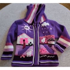 New Hand Made Peruvian Child's Sweater Zip Up With Hood Laid Flat Measurements: Back Of Neck To Hem 14.5" Shoulder To Sleeve 12" Armpit To Armpit 12" Underarm To Bottom Hem 8" Across Bottom Hem 12" Zipper 11" Hooded Purple Cotton Outerwear, Purple Hooded Cotton Outerwear, Cute Purple Cotton Hoodie, Cozy Purple Hoodie For Winter, Purple Knitted Long Sleeve Outerwear, Cozy Winter Hoodie For Playtime, Casual Hooded Purple Sweater, Casual Purple Hooded Sweater, Cute Purple Winter Outerwear