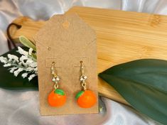 These vibrant earrings feature handcrafted oranges made from polymer clay, capturing the fresh, sunny essence of summer, adding fun to any occasion or outfit Orange Earrings For Summer Gifting, Peach Earrings For Summer Gift, Summer Gift Earrings In Polymer Clay, Summer Gift Polymer Clay Earrings, Summer Polymer Clay Earrings For Gifts, Handmade Orange Earrings For Summer, Orange Dangle Earrings In Polymer Clay, Orange Dangle Earrings Polymer Clay, Orange Clay Jewelry For Gifts