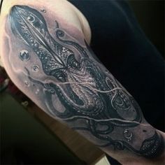 an octopus tattoo on the arm and shoulder