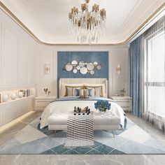 a white and blue bedroom with chandelier hanging from the ceiling, bed in center