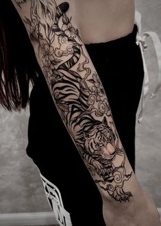 a woman with a tiger tattoo on her arm