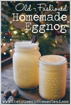 two jars filled with homemade eggnog sitting on top of a table next to a christmas tree