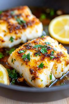 some fish and lemons in a pan on a table