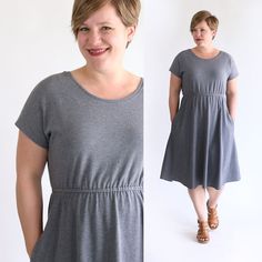 a woman in grey dress standing next to a white wall