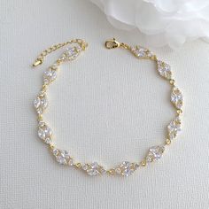 The Hayley gold crystal wedding bracelet is a beautiful, elegant and delicate wedding bracelet. Slim but full of sparkle, it has just the right touch of glam for your bridal look. The crystal bridal bracelet is made with prong set cubic zirconia round and marquise halo style crystals. Material used is 14k gold plated brass. The cubic zirconia bracelet is available in silver/rhodium finish, rose gold finish and 14k gold finish. # Please select Length of the bracelet, it comes with a 3 cm extensio Gold Bracelet Wedding, Backdrop Necklace, Delicate Wedding, Backdrops Necklace, Bracelet Rose Gold, Gold Bridal Jewellery Sets, Bridal Jewelry Set, Detailed Necklace, Rose Gold Crystal