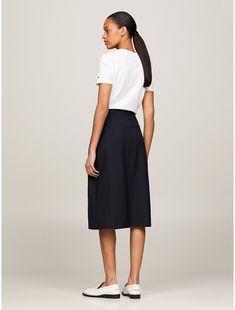 Tommy Hilfiger women's skirt. Our sophisticated spin on the midi skirt boasts an asymmetrical wrap closure and gold-tone TH crest buttons for an elevated finish.  Material: 47% Viscose. Classic Asymmetrical Skirt For Work, Relaxed Fit Midi Wrap Skirt For Work, Relaxed Midi Skirt For Workwear, Relaxed Midi Skirt For Business Casual, Relaxed Fit Lined Wrap Skirt For Work, Lined Midi Wrap Skirt For Workwear, Midi Wrap Skirt For Workwear, Relaxed Wrap Skirt For Workwear, Midi Wrap Skirt With Lining For Work