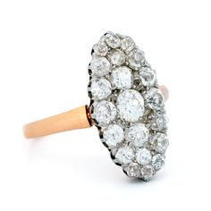 an antique diamond cluster ring in yellow gold and white diamonds, circa 1920's