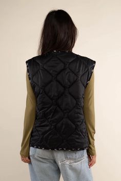 Reversible boxy quilted vest with contrast binding and side pockets. Reverse side is a 100% Rayon ditsy print. This garment is quilted in Los Angeles with 4oz poly-fill. *Side pockets are only on the Self (Black Nylon) side. Reversible side (Black Print) does not have side pockets. *All sale items are final sale* Made in United States Fabric: Self: 100% Nylon Lining : 100 % Rayon Hand wash Ditsy Print, Reversible Vest, Quilted Vest, Scarf Men, Mens Skin Care, Black Nylon, Black Nylons, Ugly Sweater, Black Media