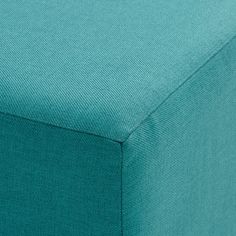 a close up view of the fabric on a blue bed spreader with no sheets