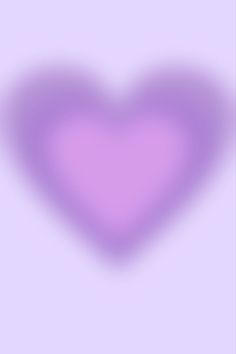 a purple heart shaped object is shown in the middle of a blurry background,