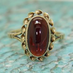 Vintage garnet cabochon 9ct yellow gold ring. Fully hallmarked for 9ct gold assayed in Birmingham in 1976. In good vintage condition. This will arrive in a ring box. An attractive ring! Weight 3.32g. Size O, US size 7 1/4. Garnet measures 13.5mm by 7mm. Victorian Rings Vintage, Vintage Ring Box, Cabochon Ruby, Wrap Jewelry, Victorian Rings, Garnet Jewelry, Garnet Rings, Yellow Gold Ring, Multi Stone Ring