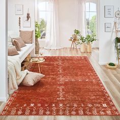 a living room filled with lots of furniture and decor on top of a wooden floor