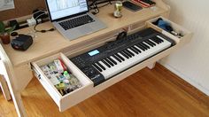 a laptop computer sitting on top of a wooden desk next to a keyboard and mouse