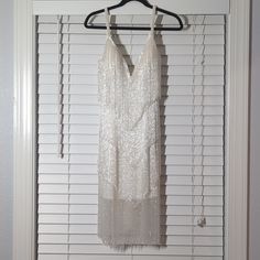 Nwt Jovani Beaded Flapper Dress Size 8 Color Is Ivory And It Comes With Some Extra Beads Glamorous White Sequin V-neck Dress, Glamorous White V-neck Sequin Dress, White Sleeveless Flapper Dress, Glamorous Sleeveless White Flapper Dress, White Sleeveless Glamorous Flapper Dress, White Glamorous Flapper Dress, Glamorous White Flapper Dress For Evening, Elegant White Flapper Dress For Cocktail, Elegant White Flapper Cocktail Dress