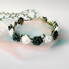 a white and green flower crown on top of a table