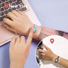 a person using a smart watch on their wrist next to a laptop with the word paris