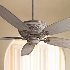 a ceiling fan that is hanging from the ceiling