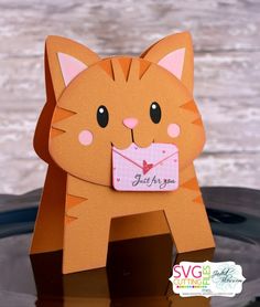 a close up of a paper cat on a table