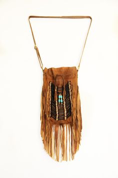 American native style handmade leather bag. Large size Bone bead choker attached as decoration Fully lined inside with one pocket. strap can be adjusted to several lengths. Material: leather, cow bones 26 cm wide,39 cm long. total long include leather fringes 60- 62 cm Best finishing quality Please note that our products are handmade with some natural materials. For this reason the used materials such as leather and feathers may have slight variations in color. Please do not forget to send us a Bohemian Brown Shoulder Bag For Festival, Bohemian Festival Bags With Beaded Fringe, Bohemian Brown Bag With Beaded Fringe, Hippie Brown Handmade Shoulder Bag, Hippie Handmade Brown Shoulder Bag, Brown Artisan Shoulder Bag For Festivals, Bohemian Brown Shoulder Bag With Fringe, Traditional Brown Fringe Bag, Traditional Fringe Bags For Festival