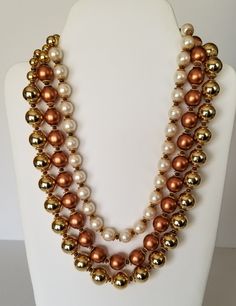 Valentino Italy Triple Strand Multicolor Bead Oversized Beaded Statement Runway Necklace, Signed. A long, beautiful dressy necklace that goes from day to night in a flash! The triple strand necklace is made up of 1 strand of 12mm warm white faux pearls, 1 of 14mm copper-colored beads, and one of 16mm bright gold beads. Each bead is separated with discs of matte gold. The clasp is a checkerboard of bright and matte gold with bright round white rhinestones, worn in the back or the front for two totally different looks.  The necklace is 21 inches long and very pretty. Substantial, with lots of swing, fun to wear. Turn the most ordinary outfit extraordinary! Signed "V Italy Made" on a hangtag attached to the clasp. Valentino Runway, Runway Necklace, Fabric Envelope, Glamorous Jewelry, Modern Jewellery Design, Rhinestone Choker, Cabochon Pendant, Star Jewelry, White Rhinestone