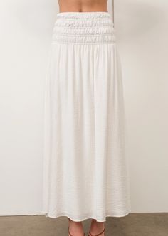 Summer Breeze Maxi Skirt, a blend of comfort and relaxed elegance. Featuring a smocked waist, this skirt can be dressed up or down for any occasion, making it a must-have for the season. Ethically sourced and Fair Trade. Material & Care: Made from 80% Rayon and 20% Nylon with a 100% Polyester lining, this skirt is both comfortable and breathable. For best care, machine wash cold with like colors, gentle cycle. Hang to dry. Size & Fit: Model is 5'9" wearing size small Bust 31", Waist 24", Hip 35 White Skirt With Elastic Waistband And Relaxed Fit, White Relaxed Fit Skirt With Elastic Waistband, Modest Bottoms With Elastic Waistband For Day Out, Relaxed Fit Tiered Maxi Skirt With Elastic Waistband, Casual Flowy Maxi Skirt With Elastic Waistband, Skirted Bottoms With Elastic Waistband For Daywear, Flowy Wide Leg Maxi Skirt For Daywear, Beach Flared Maxi Skirt With Elastic Waistband, Spring Maxi Skirt With Elastic Waistband For Daywear