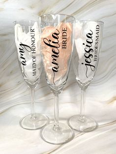 three wine glasses with the words bride and groom written on them, sitting next to each other