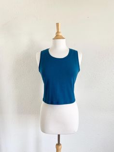 Womens basic cropped cotton knit tank top.  This is a simple semi fitted cropped length tank top that can be worn alone or layered. Made of soft stretchy cotton Lycra fabric. Machine washable.  Length from shoulder to hem is about 17.5" on size Small and increases 1/2" each size up.    See swatch chart in the last photos for available colors.  Garments are Made To Order Please allow 7-10 days for your item to be sewn Below are my standard size measurements, which are simply a guideline, if you would like to include your personal measurements in the notes to seller box during checkout, I will be sure to make you the best fit ~ if you have any questions feel free to ask :)  BASIC SIZING   XSmall 0-2 Bust 33-34, Waist 25-26, Hip 35-36  SMALL 4-6 Bust 35-36, Waist 27-28, Hip 37-38  MEDIUM 8-10 High Stretch Sleeveless Cotton Top, Fitted Summer Muscle Tee Tank, High Stretch Cotton Sleeveless Top, Fitted Summer Tank Muscle Tee, Fitted Tank Muscle Tee For Summer, Sporty Stretch Cropped Shirt For Summer, Summer Cropped Fitted Tank Top, Cropped Fitted Tank Top For Summer, Casual Seamless Crop Top For Everyday