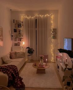 a living room filled with furniture and a flat screen tv on top of a wooden table