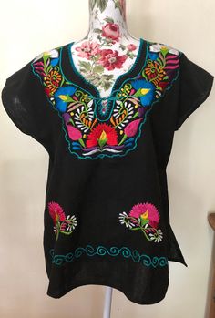 Mexican Embroider Women's Blouse/Tunic. Refer to photos or message me for questions. Length: approx. 25 1/2" Width: approx. 23" Multicolor Embroidered Short Sleeve Vacation Top, Multicolor Embroidery Short Sleeve Tops For Vacation, Multicolor Embroidered Short Sleeve Top For Vacation, Folk Style Multicolor Vacation Tops, Casual Short Sleeve Tunic For Festival, Multicolor Short Sleeve Embroidered Top For Vacation, Folk Style Multicolor Tunic Top, Folk Style Tunic Tops For Beach, Casual Short Sleeve Tunic With Floral Embroidery