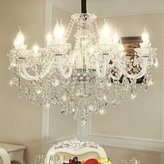 a chandelier hanging over a dining room table