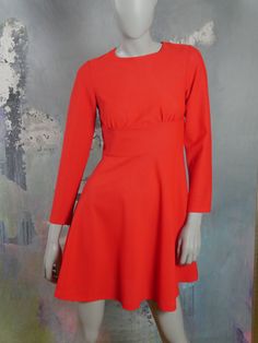 This 1960s Swedish vintage flame orange mini dress has a round collarless neckline, bracelet-length sleeves, and a fitted waistline with a 3.5-inch (8.89cm) wide band that gives way to a semi-flared drop to an above-the-knee hemline. A 19-inch (48.26cm) long zipper in the back makes dressing an ease. Bust = 32 inches (81cm) Shoulders = 14 inches (35.56cm) Waist = 28 inches (71.12cm) Hips = 35 inches (88.9cm) Sleeve Length = 22.5 inches (57.15cm) Dress Length = 34 inches (86.36cm) Size: 4 US, 8 U Retro Long Sleeve Orange Dresses, Fitted Vintage Orange Mini Dress, Chic Orange Knee-length Mini Dress, Vintage Orange Knee-length Dress, Vintage Short Dress, 1960s Mini Dress, 1968 Pink & Orange Dress, Orange Mini Dress, Vintage Short