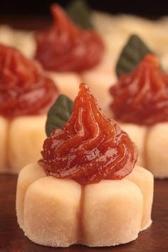 small pieces of food sitting on top of a wooden table