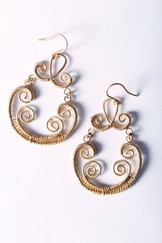 "This listing is for a pair of fabulous metalwork earrings. They dangle about 1.75\" long and are made from matte gold metalwork pendants, which I've dangled from matte gold ear wires. The pendants are made of two separate pieces, connected by gold jump rings. This separation keeps them from being too stiff so that they swing when you move." Wire Wrapped Metal Chandelier Earrings For Gift, Wire Wrapped Metal Chandelier Earrings, Wire Wrapped Brass Chandelier Earrings, Wire Wrapped Brass Chandelier Dangle Earrings, Elegant Copper Wire Drop Earrings, Elegant Nickel-free Copper Wire Earrings, Elegant Wire Dangle Wrap Earrings, Bohemian Gold Wrap Earrings With Copper Wire, Elegant Wire Wrap Dangle Earrings