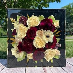 a bouquet of flowers sitting on top of a wooden table