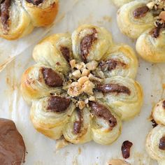 several pastries with nuts and chocolate on them