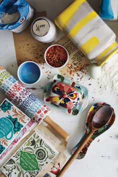 various bowls and spoons sitting on top of a table next to some paper towels