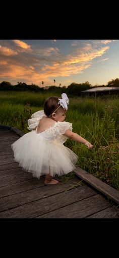 This beautiful ivory tulle dress is perfect for first birthday photoshoots, cake smash session or a flower girl dress. Dress can be custom made in sizes newborn thru 10 years of age.  Bodice top is made of a stetch knit, which is light weight and breathable.   Tulle skirt is made of 100% nylon tulle. MEASUREMENTS ARE AS FOLLOWED: 0-3 months: Waist 18" Length 9" 3-6 months: Waist 18" Length 9" 6-9 months: Waist 19" Length 9" 9-12 months: Waist 19" Length 10" 12-18 months: Waist 19.5" Length 11" 2 Tulle Dress Newborn, White Tulle Fairy Dress For Wedding, Cute White Tulle Fairy Dress, Cream Tulle Tutu Dress For Baptism, Cream Ruffled Tutu Dress For Summer, Cream Tulle Princess Dress For Baptism, Cream Tulle Skirt Tutu Dress For Baptism, Cream Princess Dress With Tulle Skirt For Party, Cute White Tulle Skirt Dress