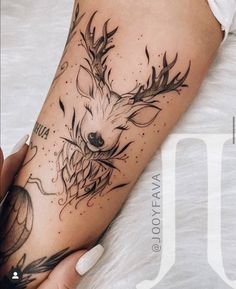 a woman's arm with a deer tattoo on the left side of her body