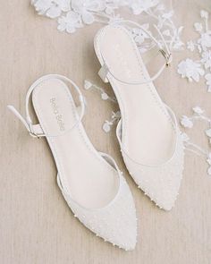 a pair of white shoes sitting on top of a table