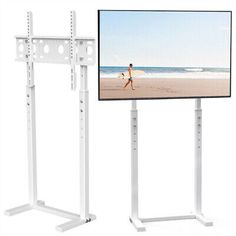 a flat screen tv mounted to the side of a white metal stand next to a beach