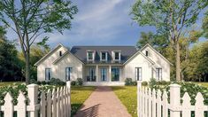 a white house with a picket fence in the front yard