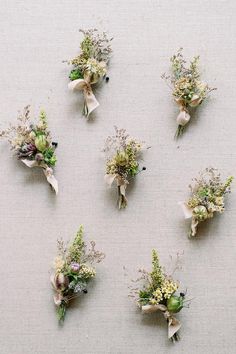 six bouquets of flowers are arranged on a table