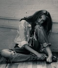 a woman sitting on the floor with her legs crossed