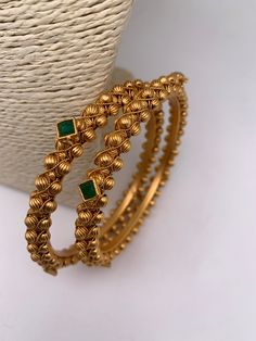 "Regal Radiance: Majestic Gold Bangle" "Aurora Adornments: Enchanting Gold Bangle" Bengali Bangles Gold, Golden Bangles Indian Design, Green Stone Necklace Indian, Bangles Gold Design, Bangle Designs Gold, Antique Gold Bangles Design, Green Stone Bangles, Bangles Jewelry Designs Gold, Gold Bangles Set