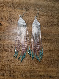 Hand beaded chandelier earrings with a sterling silver earring hook with a 33/4in drop length White Long Drop Earrings With Colorful Beads, White Beaded Fringe Long Drop Earrings, White Long Drop Beaded Fringe Earrings, Beaded Fringe Dangle Earrings, Long Drop Beaded Earrings, White Long Drop Jewelry With Beaded Fringe, Silver Chandelier Earrings With Colorful Beads, White Beaded Chain Earrings, Dangle Beads With Beaded Fringe For Jewelry Making