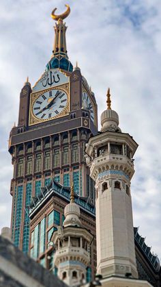 a large clock tower on top of a building with a sky in the back ground