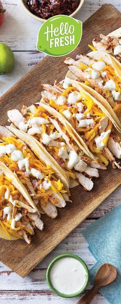 chicken and cheese tacos on a cutting board