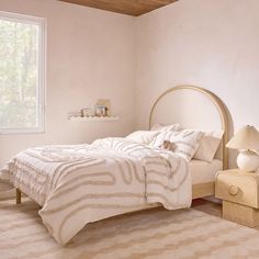 a bedroom with a bed, nightstand and window