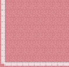 a ruler with a pink background that has small flowers on it